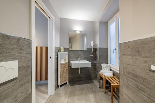 a bathroom with a sink and a mirror at PRIMA FILA Premium Guest House in Sanremo