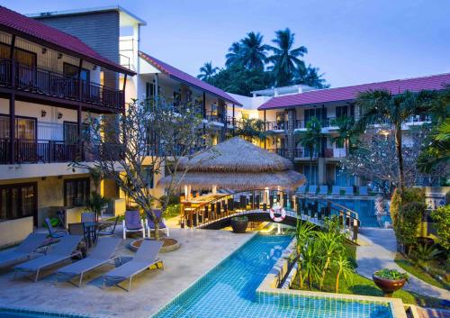 un hôtel avec une piscine et un complexe dans l'établissement Baan Karon Resort, à Karon Beach