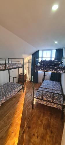 a room with three bunk beds in it at Old House Ureki in Ureki