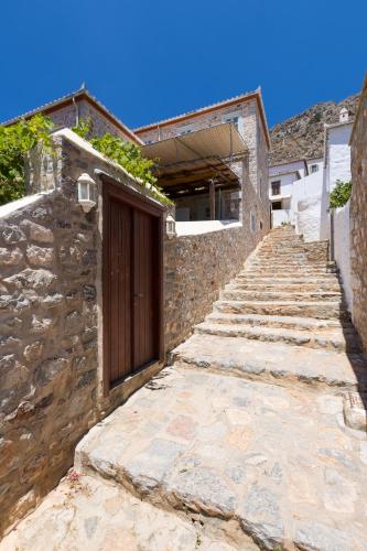 a stone pathway leading up to a building with a door at Gaia accommodation Hydras in Hydra