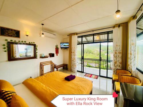 a bedroom with a bed and a large window at Rock Face Palace in Ella