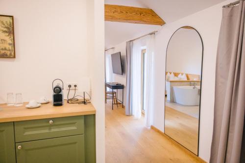 a bathroom with a green cabinet and a mirror at Gut Herzogberg in Sonntagberg