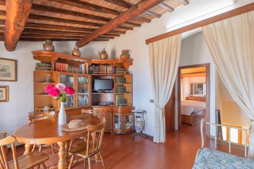 a living room with a table and a bedroom at Domina House by ElbaSummer in Marciana