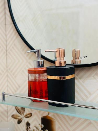 a shelf with two bottles of soap on it at Green Village in Ella