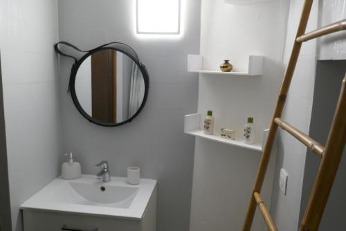 a bathroom with a sink and a mirror at Ondas Eco-Gîtes in Arsagne