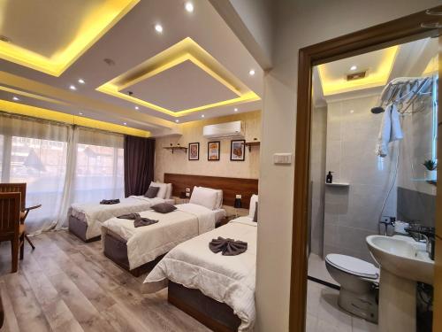 a hotel room with two beds and a bathroom at swiss hotel cairo downtown in Cairo