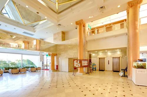 a lobby of a building with a large ceiling at Resort Hotel Bel Paraiso in Nakijin