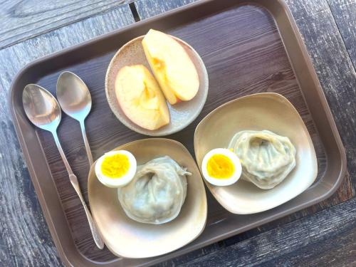 a tray with three dev eggs and bread and spoons at Tohyang Traditional House in Bonghwa