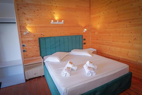 a bedroom with a bed with towels on it at Dolanit Hotels Lalez in Draç
