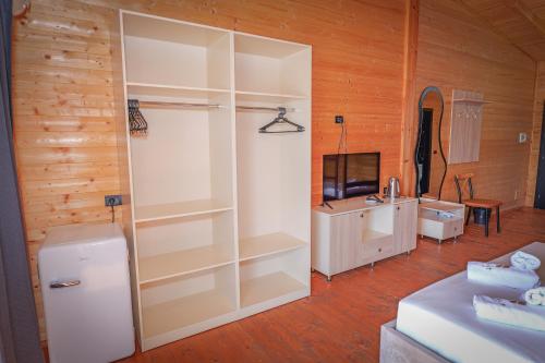 a room with a white closet with a sink and a television at Dolanit Hotels Lalez in Draç