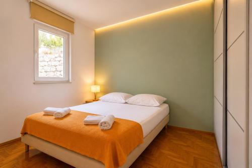 a bedroom with a bed with towels on it at Lux Apartman Sofia in Sveti Stefan