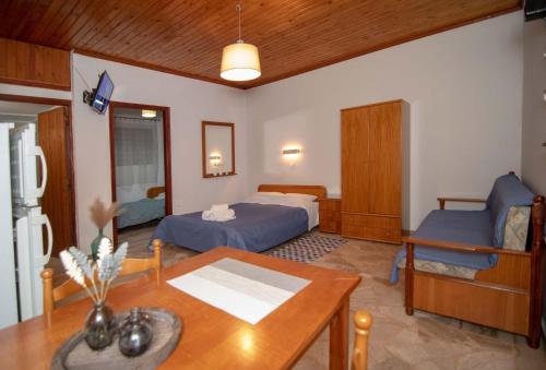 a living room with a bed and a table at Kastraki Villas in Nafplio