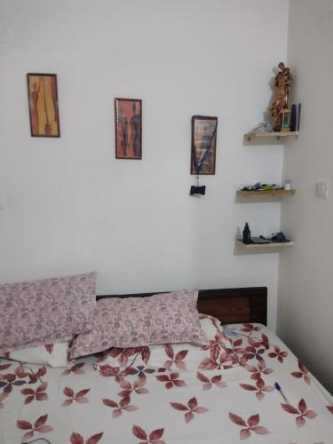 a bedroom with a bed and four pictures on the wall at 2 BHK full apartment in Mohali