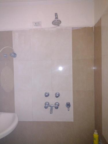 a bathroom with a shower with a sink and a toilet at 2 BHK full apartment in Mohali