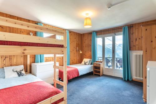 a bedroom with two bunk beds and a window at Mont Gele Hotel in Verbier