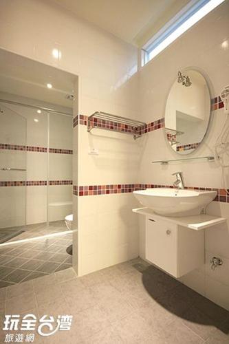 a bathroom with a sink and a mirror and a shower at 歐拉民宿 l 大空間包棟 l 親子溜滑梯 l 專業音響 in Taitung City