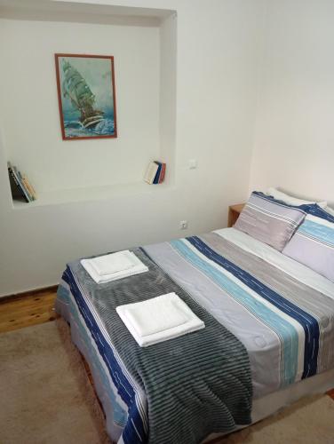 a bedroom with a bed with two towels on it at Anatoli's house in Kastoria