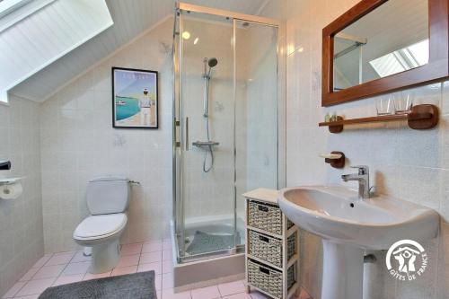 a bathroom with a sink toilet and a shower at Des puits in Locoal-Mendon