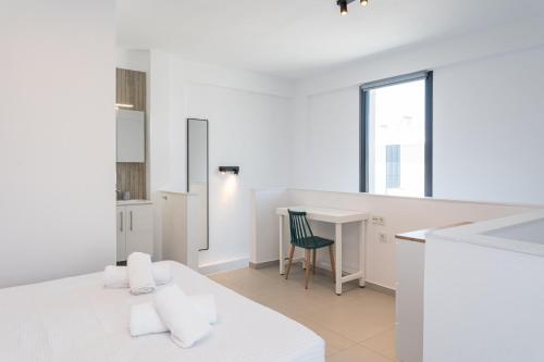 a white room with a kitchen and a table at Nefeli & Nefeli Luxury Residential Complexes in Ofrínion