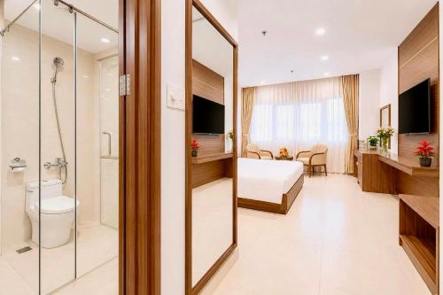 a hotel room with a bedroom and a bathroom at T78 Luxury Hotel in Ho Chi Minh City
