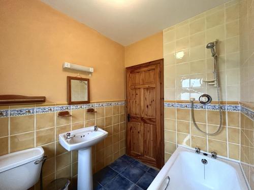 a bathroom with a tub and a sink and a shower at Twelve Bens Lodge in Recess