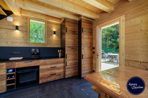 a kitchen with wooden walls and a wooden table at Cozy Chalet with Terrace Peaceful Nature Views in Bluffy