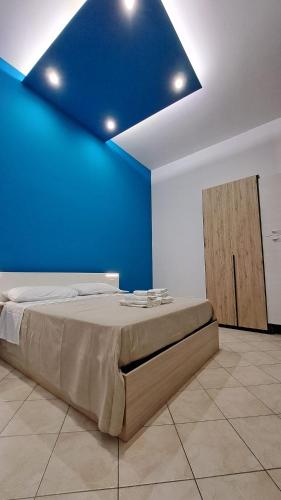 a bedroom with a bed with a blue ceiling at Casa Cirillo in Marigliano