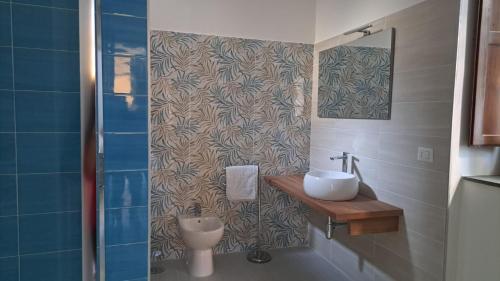 a bathroom with a sink and a toilet at Casa Cirillo in Marigliano