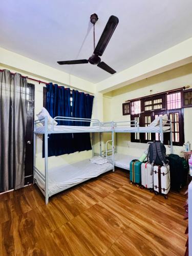 a room with two bunk beds and luggage at Awara Hostels and Dormitory in Lucknow
