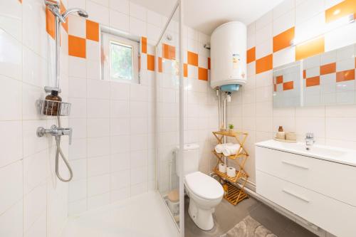 a bathroom with a shower and a toilet and a sink at Nüma Studio - Orly Paris in Montgeron