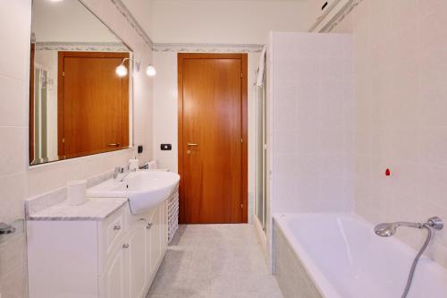 a white bathroom with a tub and a sink and a bath tub at Villa Elena in San Severino Marche