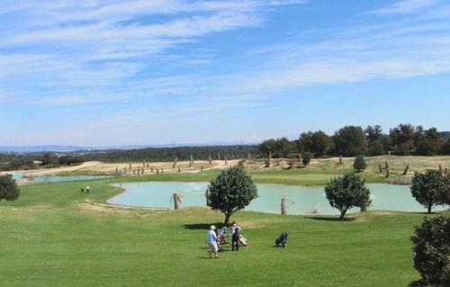a group of people standing in the grass near a lake at Appartement 3 étoiles - ccbgeff in Cabriès