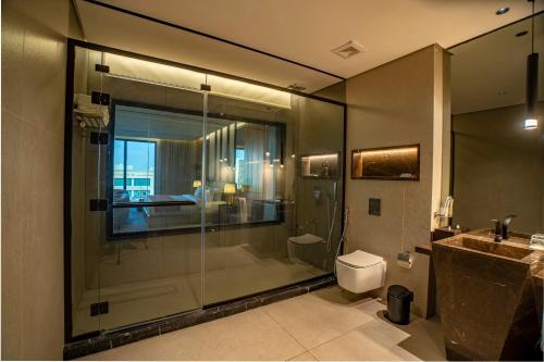 a bathroom with a shower and a toilet and a sink at فندق ليماكو in Najran
