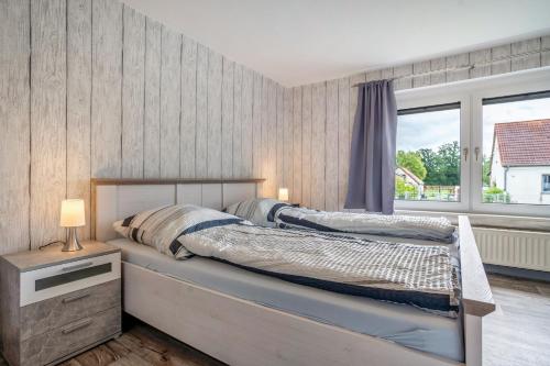a bedroom with a bed and a window at Ferienwohnung 2 in Gribow
