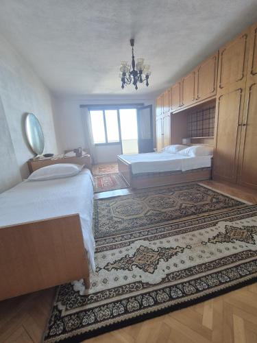 a large bedroom with two beds and a rug at Guest House Čović in Tučepi