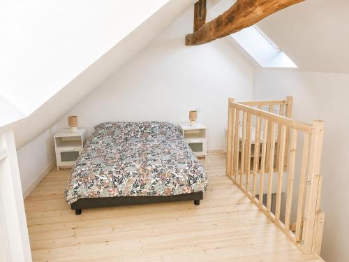 a bedroom with a bed and a staircase at Duplex de charme au coeur de Beaugency in Beaugency