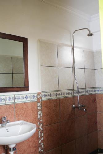 a bathroom with a sink and a shower at We Travel Hostel in Moshi
