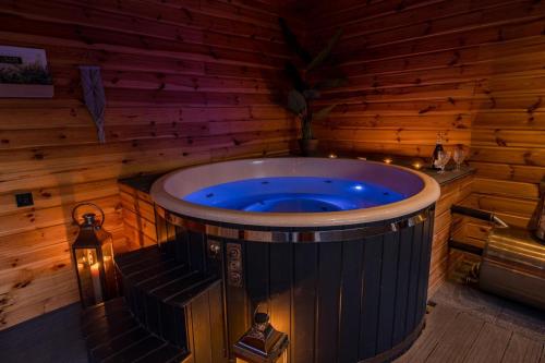 a jacuzzi tub in a room with wooden walls at Country house in Dziemiany