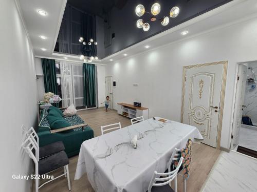 a living room with a white table and a couch at Коттедж в Sunny Beach in Chok-Tal
