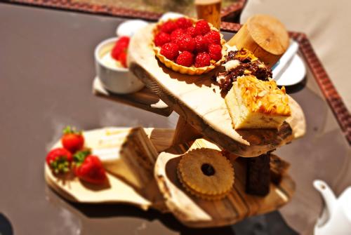 a wooden table topped with desserts and strawberries at The Green House in Bournemouth