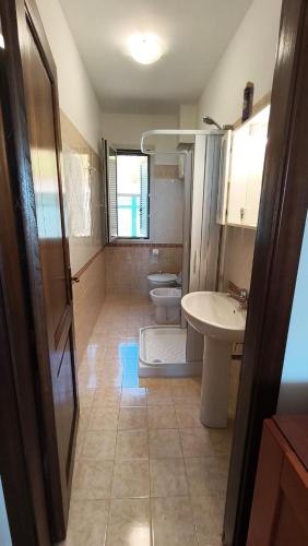 a bathroom with two toilets and a sink at Casa Vacanze Sofì in Ascea