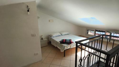 a bedroom with a bed in a room with a staircase at Casa Vacanze Sofì in Ascea