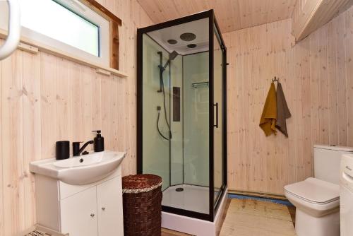 a bathroom with a shower and a sink at 4gilės sodyba Alytaus rajone in Kružiūnai