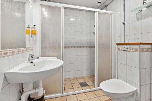 a bathroom with a sink and a toilet and a shower at Frimurarehotellet; Sure Hotel Collection by Best Western in Kalmar