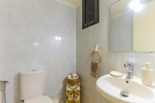 a bathroom with a white toilet and a sink at Mauve et Miel 2-BR Apartment In Batroun in Batroûn