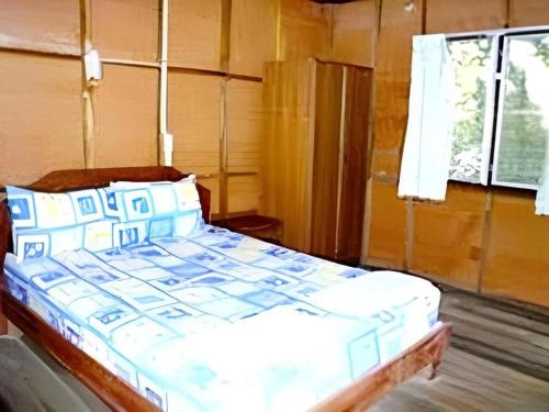 a bed with blue and white pillows in a room at Green Valley Resort in Tonsai Beach