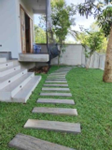 a garden with a bench and grass at Monara Blue Beach in Dickwella