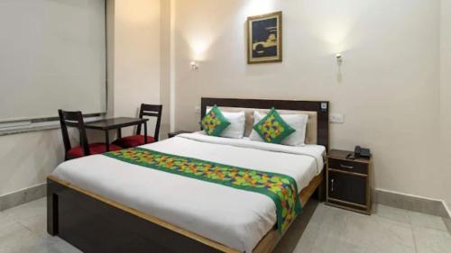 a bedroom with a large bed and a table at Zouk Homes in Rishīkesh