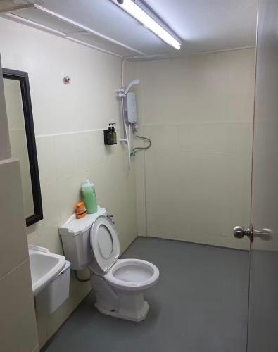 a bathroom with a toilet and a sink at Nangyang lodge in Malacca