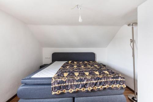 a small bedroom with a bed in a attic at Loft in Augsburg